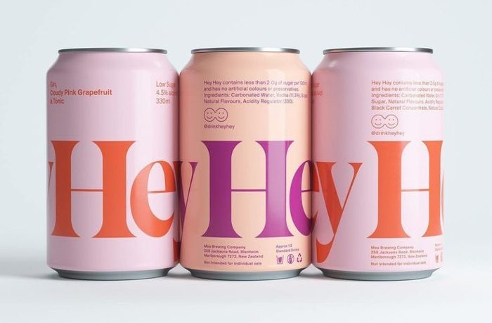 Grapefruit-pink brand packaging, big serif type