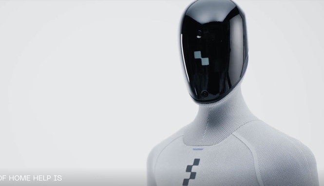 Figure humanoid robot with a black screen face in a studio