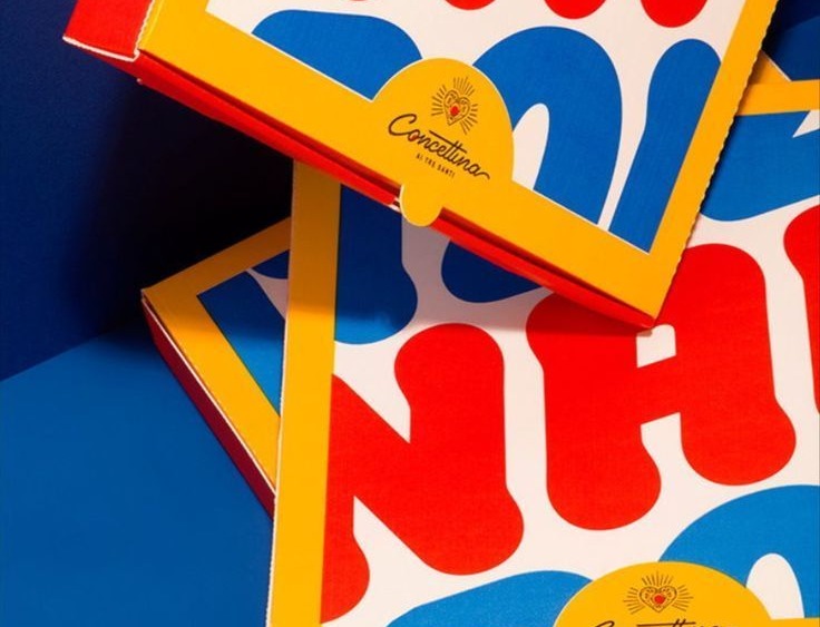 Primary-colour pizza boxes stacked at angles