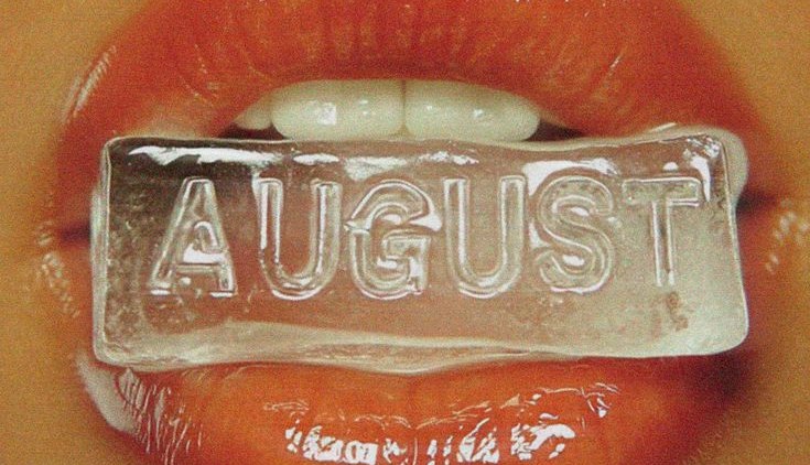 AUGUST cast in an ice cube held between red lips
