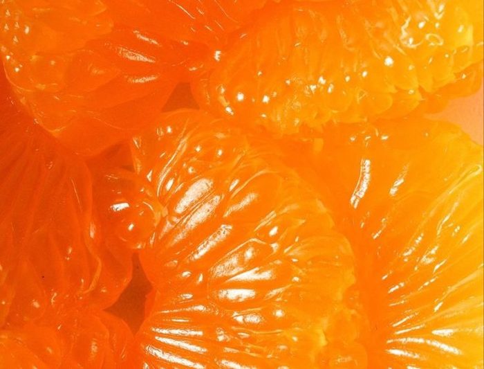 Wet supremes pulled apart, pulp catching the light